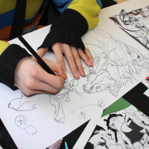 Person drawing comic book characters